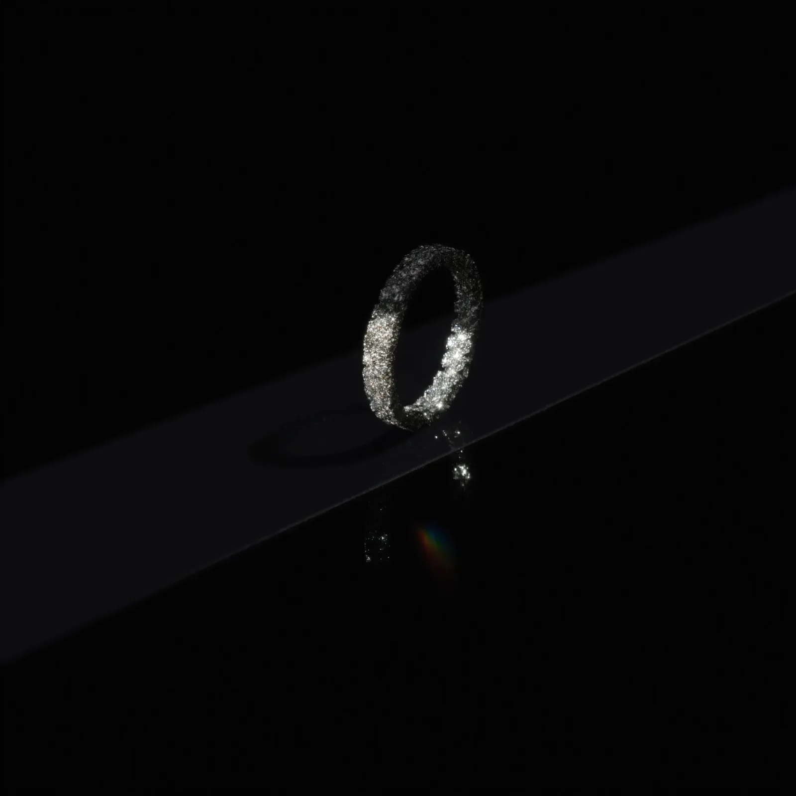 Pavé-set diamond eternity band standing on edge against a dark background.