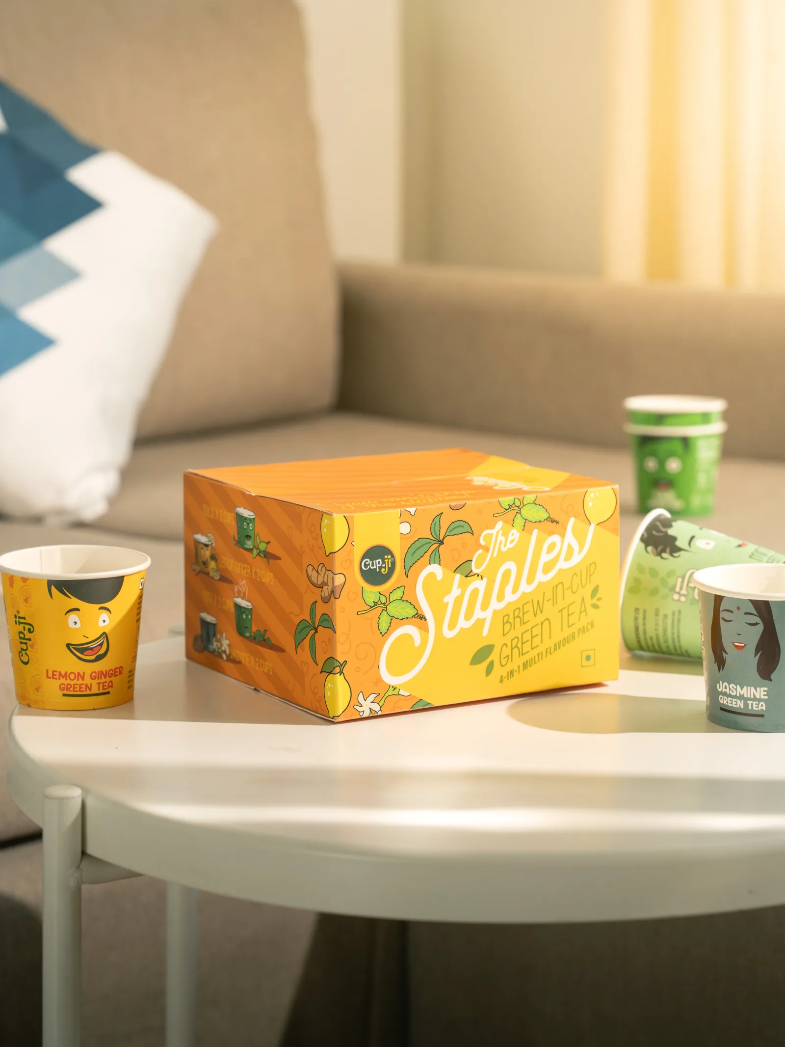 The Staples gift box on a coffee table with a sofa falling out of focus behind it.