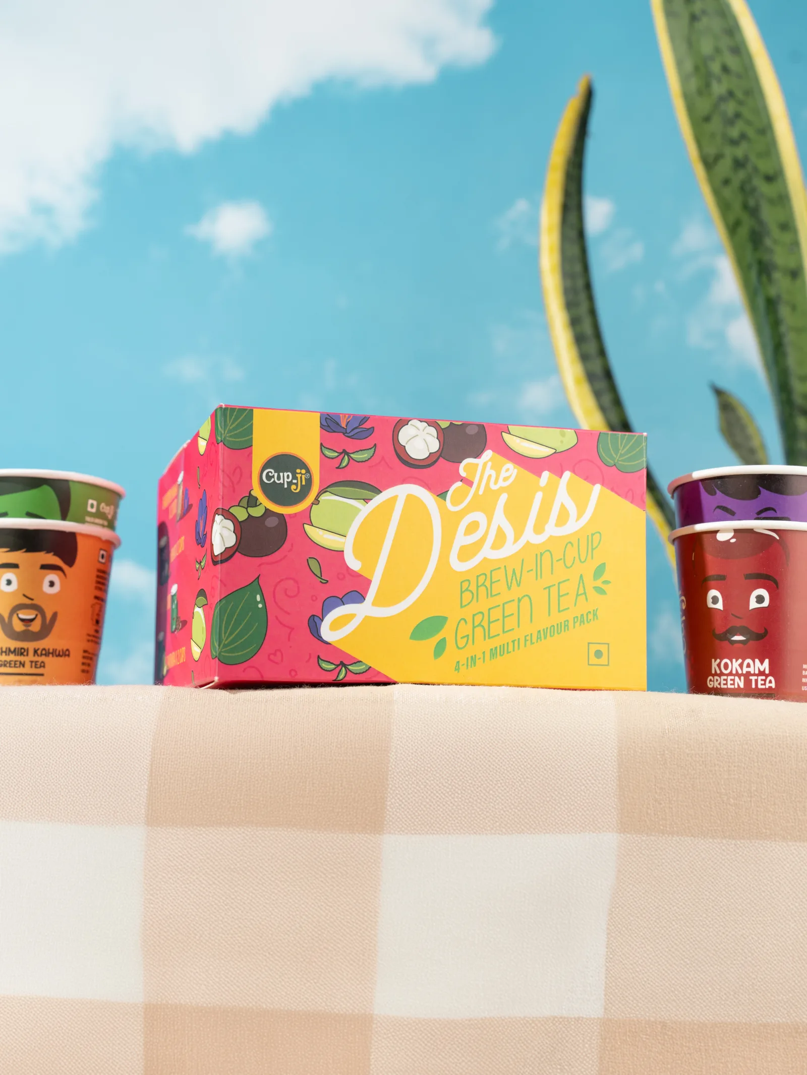 The Desis gift box shot from a low angle against open sky on a gingham cloth.