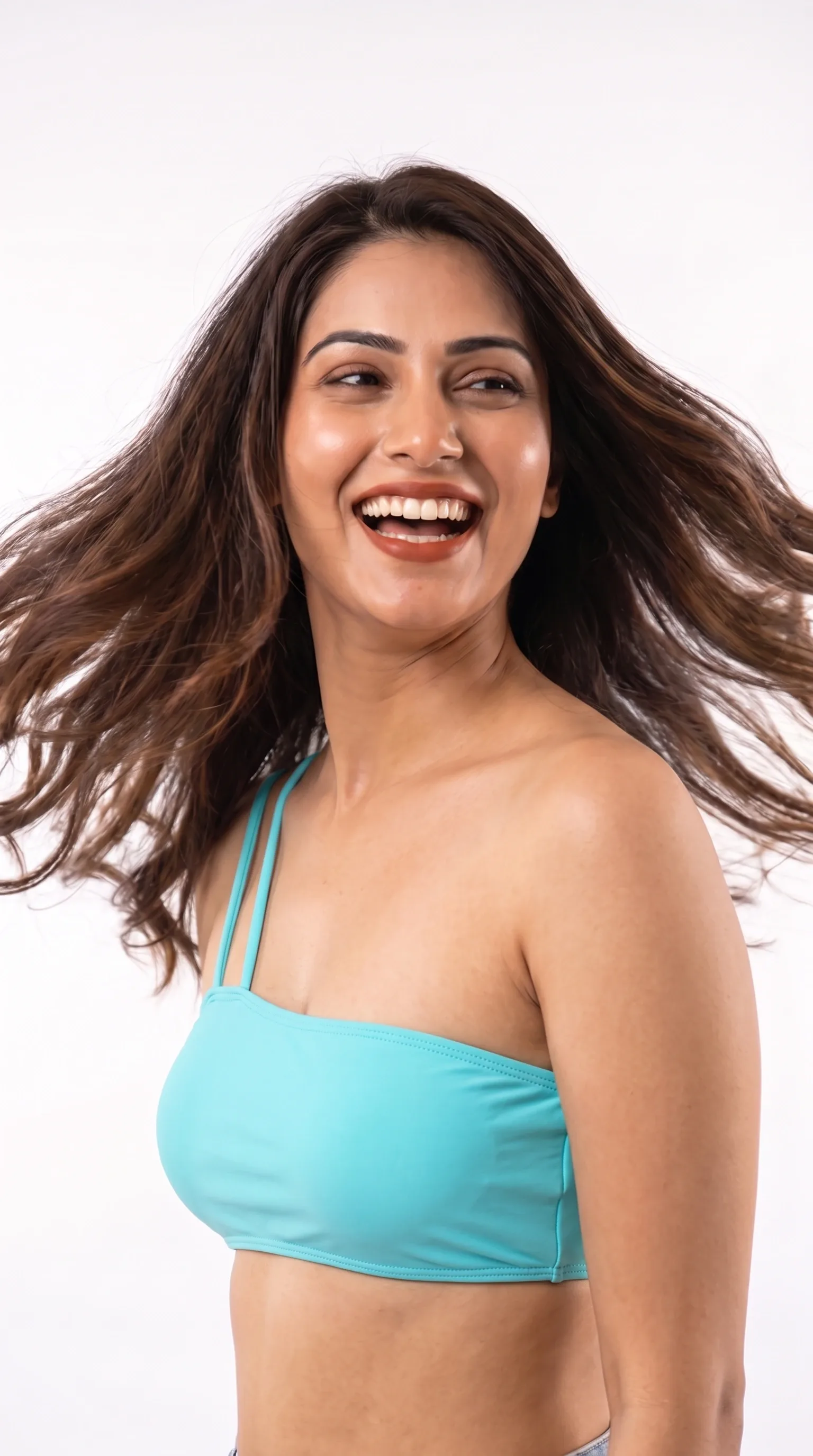 Three-quarter shot of a bikini set, model laughing with hair caught in motion.